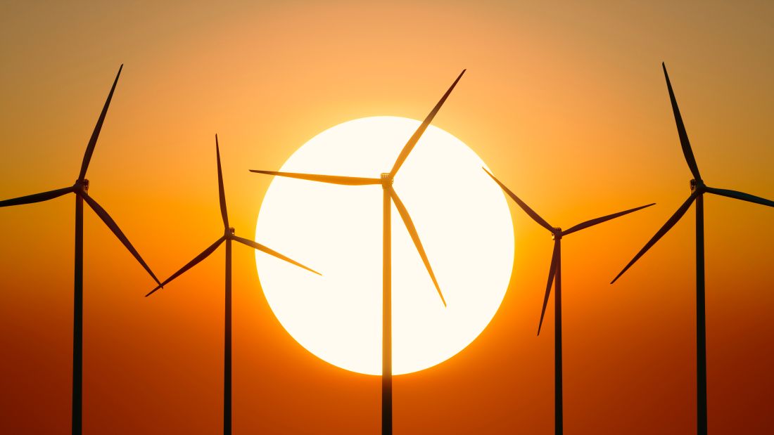Wind farm against sunset